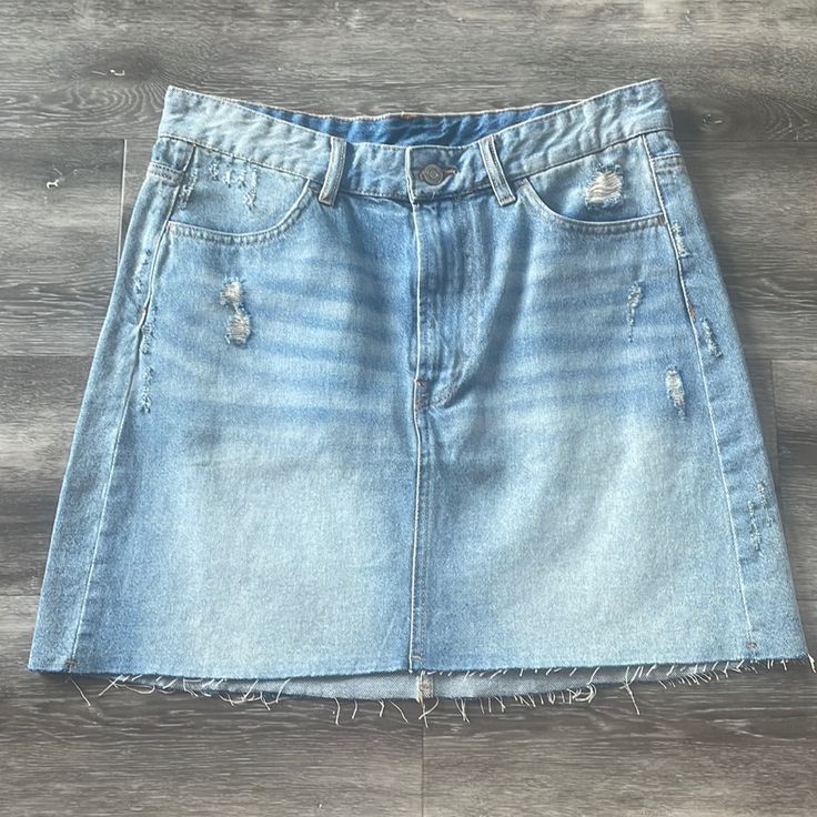 H&M High Waisted Denim Distressed Skirt. Size 8. Never Worn, New And With Tags! Light Wash Cotton Mini Skirt With Frayed Hem, Light Wash Cotton Cutoff Skirt, Ripped Mid-rise Cotton Denim Skirt, High Rise Light Wash Denim Mini Skirt, Ripped Mid-rise Denim Skirt, Ripped Light Wash Denim Skirt, Ripped Medium Wash Cotton Denim Skirt, Light Wash High Waist Distressed Denim Skirt, High Waist Light Wash Mini Skirt With Frayed Hem