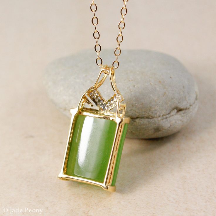 "Here is a AAA grade Siberian emerald green nephrite jade set in solid 18KT yellow gold and accented with round full cut white diamonds. This pendant is designed with a chevron accent. It is modern with simple clean lines. The jade is natural and untreated. This nephrite jade has a beautiful glowing apple green color. Stone & Dimensions: Natural Untreated gem grade AAA Siberian Emerald Green Nephrite Jade: approximately 11.2 carats 16mm long x 12mm wide x 5mm thick, Overall size of pendant: Green Rectangular Pendant Jewelry For Formal Occasions, Green Rectangular Necklace For Formal Occasions, Green Rectangular Pendant For Formal Occasions, Art Deco Jade Jewelry For Formal Occasions, Formal Green Rectangular Necklace, Formal Art Deco Jade Jewelry, Rectangular Green Emerald Jewelry, Green Rectangular Emerald Jewelry, Green Emerald Rectangular Stone Jewelry