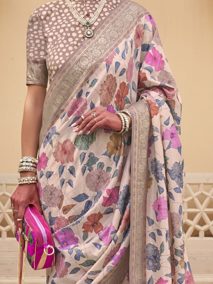 This stunning ensemble is perfect for weddings, festivals, and other special occasions, making you the center of attention wherever you go. The off-white color of the saree paired with intricate floral print and zari weaving work exudes elegance and sophistication.
This saree and blouse set is designed to make you feel like a goddess. The 5.50 meters of saree material allows for easy draping and styling, while the unstitched blouse material gives you the freedom to customize the fit according to Traditional White Blouse Piece With Printed Border, Traditional White Sets With Printed Border, White Sets With Printed Border For Navratri, Cream Art Silk Blouse Piece For Festivals, Wedding Tussar Silk Saree In Off White, White Art Silk Traditional Wear With Printed Border, Traditional Wear With Printed Border For Wedding And Navratri, Festive Off White Sets With Floral Print, Festive Off White Floral Print Sets