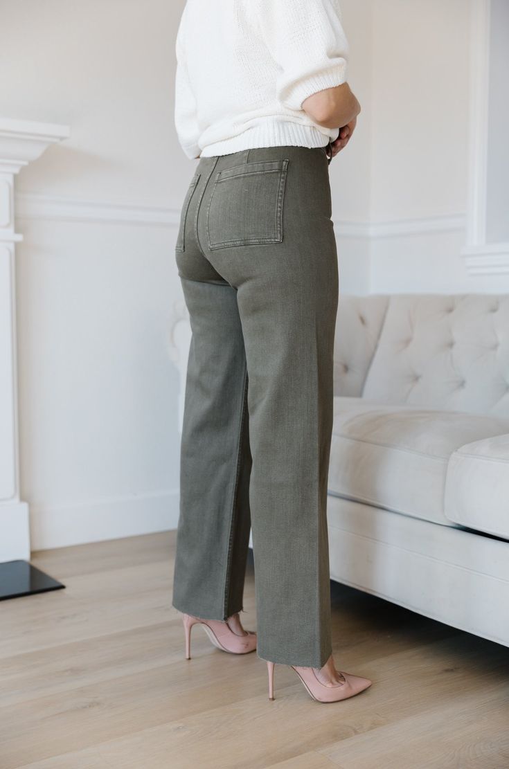 The Olive Green Wide Leg Jeans are an essential addition to any wardrobe. These classic jeans feature a flattering high waist, wide leg fit, and cropped style that flatters your figure and ensures comfort and flexibility throughout the day. Perfect for all seasons, these jeans provide timeless elegance and style. olive green wide leg pants high waist comfort stretch raw hem 98% cotton 2% spandex machine wash cold model is wearing a small SIZING CHART FOR THE JEANS: Small: fits sizing 25-26 Mediu Everyday Wide Leg Bottoms For Fall, Straight Leg Flare Jeans For Elevated Casual Look, Straight Leg Bottoms For Elevated Casual Fall Wear, Trendy Mid-rise Wide Leg Pants For Everyday, Everyday Wide Leg Pants For Fall, Everyday Wide Leg Flare Jeans For Fall, Chic Everyday Wide Leg Pants With Five Pockets, Wide Leg Flare Jeans For Elevated Casual Fall Wear, Everyday Cropped Leg Bottoms For Fall