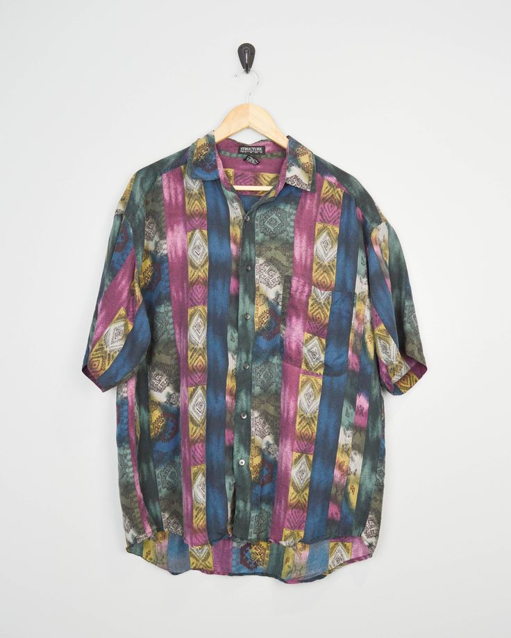 90s print shirt by Structure. Fantastic print. Listed as a size Large. Pocket on the chest. Great vintage condition. Please see detailed measurements below as vintage sizes can sometimes run small and fit preferences and body types vary. Spend $35 or more in the U.S. to get free shipping. To see more 90s items, click on the link below: www.etsy.com/shop/JusticeAndFreedom?ref=hdr_shop_menu&search_query=90s ✂-----Measurements Chest (armpit to armpit): 25 inches Length Front: 29 inches Length Back: Multicolor Collared Shirt With All Over Print, Patterned Graphic Print Button-up Camp Shirt, Patterned Camp Collar Shirt With Graphic Print, Retro Patterned Printed Shirt, Multicolor Graphic Print Button-up Short Sleeve Shirt, Short Sleeve Shirt With Retro Multicolor Print, Multicolor Printed Button-up Camp Shirt, Patterned Collared Hawaiian Shirt With All Over Print, Multicolor Retro Print Short Sleeve Shirt