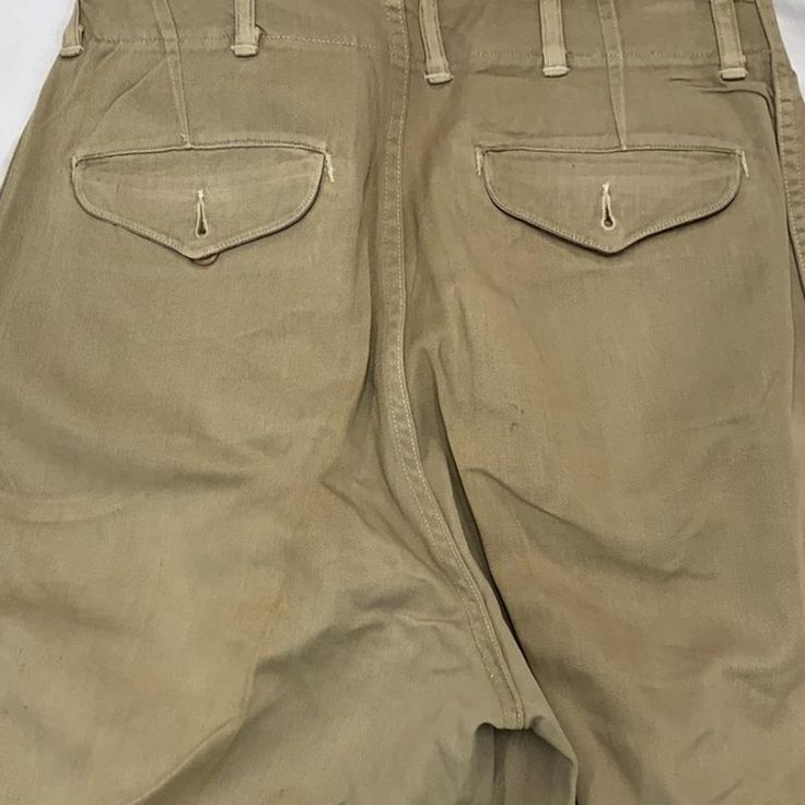 Vintage military work wear pants 1930-60s size: waist - 28” inseam-32” Military Style Khaki Wide Leg Bottoms, Military Style Wide Leg Khaki Bottoms, Military Style High Waist Khaki Pants, Military High Waist Khaki Pants, High Waist Military Pants In Khaki, High Waist Military Style Cotton Bottoms, Vintage Khaki Cargo Bottoms, High Waist Military Khaki Pants, High Waist Khaki Military Pants