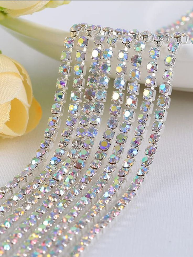 a close up of a hair comb on a table next to flowers and a rose