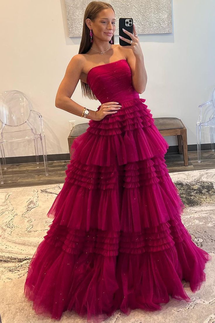 Rock this Peri-pleated, strapless tulle frock featuring tiers of ruffles, a built-in bra, and a zip-up back. Your full-length, dreamy-hued dress is perfect for a night of fun! Red Pink Prom Dress, Prom Dresses Fluffy, Layered Tulle Prom Dress, Fuchsia Prom Dress, Tiered Prom Dress, Tulle Long Prom Dress, Gown Prom Dresses, Prom Dress Inspo, Off Shoulder Evening Dress