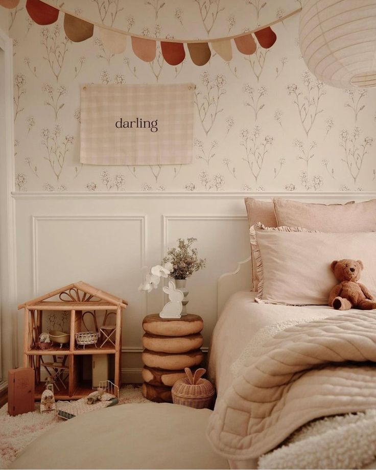 a teddy bear sitting on top of a bed in a bedroom