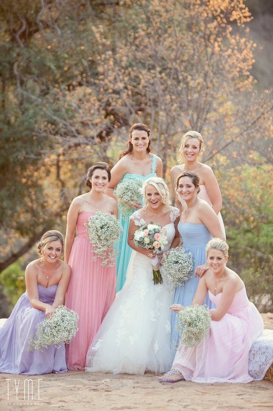 the bridesmaids are all wearing different dresses