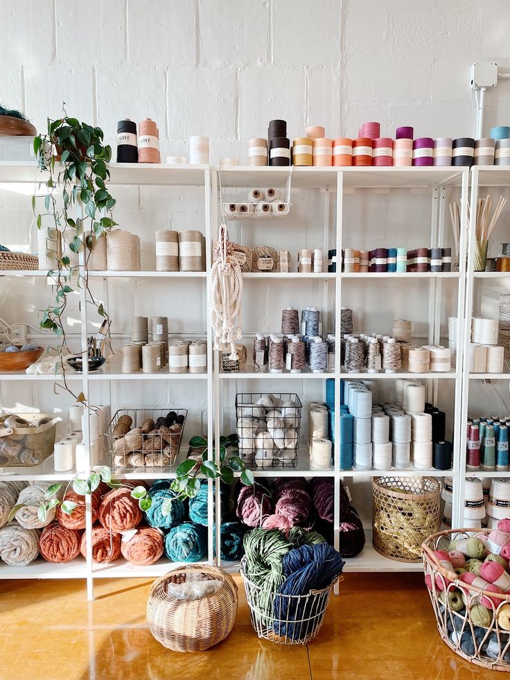 the shelves are filled with many different types of yarn