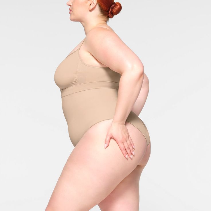 Shape your curves and feel supported in this stretchy shapewear high waisted brief with strong targeted compression at the tummy and waist, butt-shaping pockets, and a silicone interior underband that keeps it from rolling down. Hits right below the bust and features a wider crotch for added coverage and a cotton gusset. Fits true to size. | SKIMS High-Waisted Brief | Light Neutral | Seamless Sculpt High Waisted Briefs, Shapewear, Lounge Wear, High Waisted