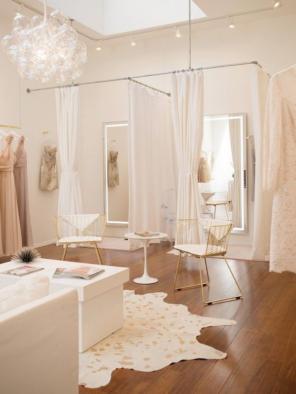 a living room filled with furniture and a chandelier