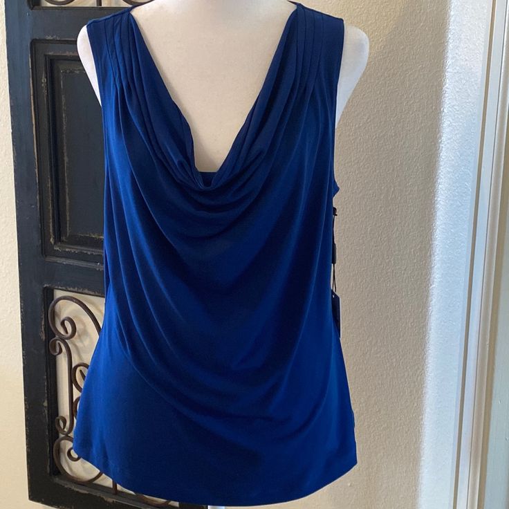 Calvin Klein Size Large Royal Blue Sleeveless Top With A Draped Neck Front. New With Tags And Pairs With Skirt And Jacket. Elegant Blue Tank Top For Spring, Elegant Blue Spring Tank Top, Elegant Blue Camisole Tank Top, Chic Blue Camisole Tank Top, Elegant Blue Summer Vest, Chic Blue Tank Vest, Elegant Blue Sleeveless Blouse, Chic Blue Tank Top For Night Out, Calvin Klein Stretch Tank Top