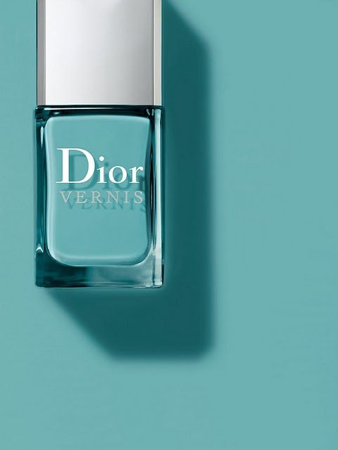 a bottle of dior vernis perfume on a blue background