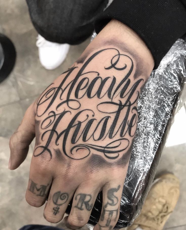 Hand Tattoo Writing Words, Hand Cursive Tattoo, Script On Hand Tattoo, Gangsta Tattoos For Women Hand, Hand Tattoos With Names, Hand And Arm Tattoos For Guys, Guy Hand Tattoos, Hand Tattoos For Guys Ideas Design, Hand Tattoo Writing