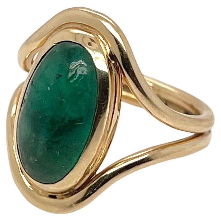 A fine Art Nouveau Signet type ring. With a smooth oval emerald cabochon bezel set in 14k gold. The setting comprised of two gold bands that frame the stone and are conjoined at the bottom. Simply a stunning emerald signet ring! Date: Early 20th Century Overall Condition: There are some naturally occurring unevenness or irregularities to the surface of the stone. Otherwise, the ring is in overall good, as-pictured, used estate condition with some fine & light surface scratches and other signs of Formal Emerald Cabochon Ring, Formal Oval Cabochon Emerald Ring, Modern Cabochon Emerald Ring For Formal Occasions, Modern Formal Emerald Cabochon Ring, Yellow Gold Emerald Ring Oval Cabochon, Yellow Gold Emerald Ring With Oval Cabochon, Fine Jewelry Emerald Oval Cabochon Ring, Fine Jewelry Emerald Ring With Oval Cabochon, Formal Yellow Gold Oval Cabochon Emerald Ring