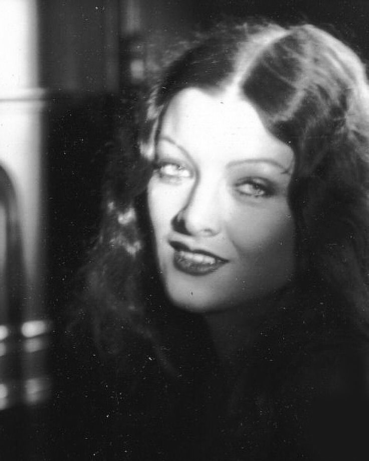 an old black and white photo of a woman with long hair