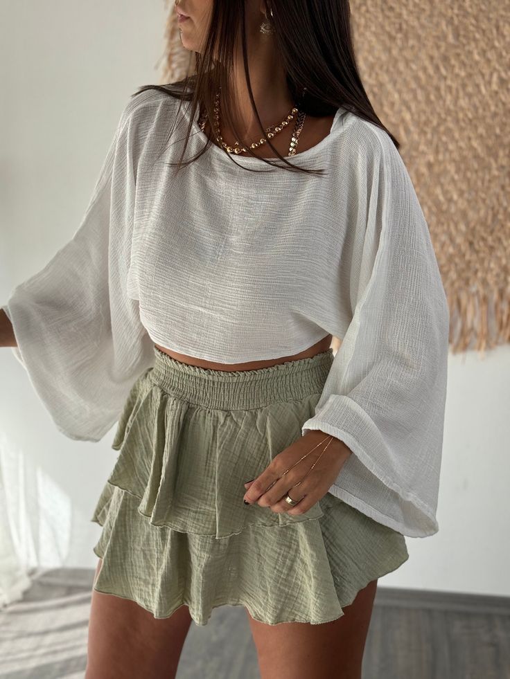 Step into summer with style in our Muslin Short Crop Top. This piece combines wide, ruffled sleeves with a lightweight cotton design, perfect for beach days or casual outings. Its gauze linen texture adds a touch of bohemian elegance, making it a versatile and fashionable choice for any wardrobe. An ideal gift for her, this top promises both comfort and chic flair. Key Features ✨ * Material: Soft, breathable organic cotton that offers luxurious comfort while being environmentally friendly. * Siz Summer Breezy Blouse With Ruffles, Breezy Summer Blouse With Ruffles, Summer Ruffle Blouse For Brunch, Flowy Ruffled Blouse For Summer, Summer Brunch Blouse With Ruffles, Breezy Ruffled Tops For Summer, Breezy Summer Tops With Ruffles, Casual Summer Peasant Top With Ruffles, Summer Breezy Ruffled Tops