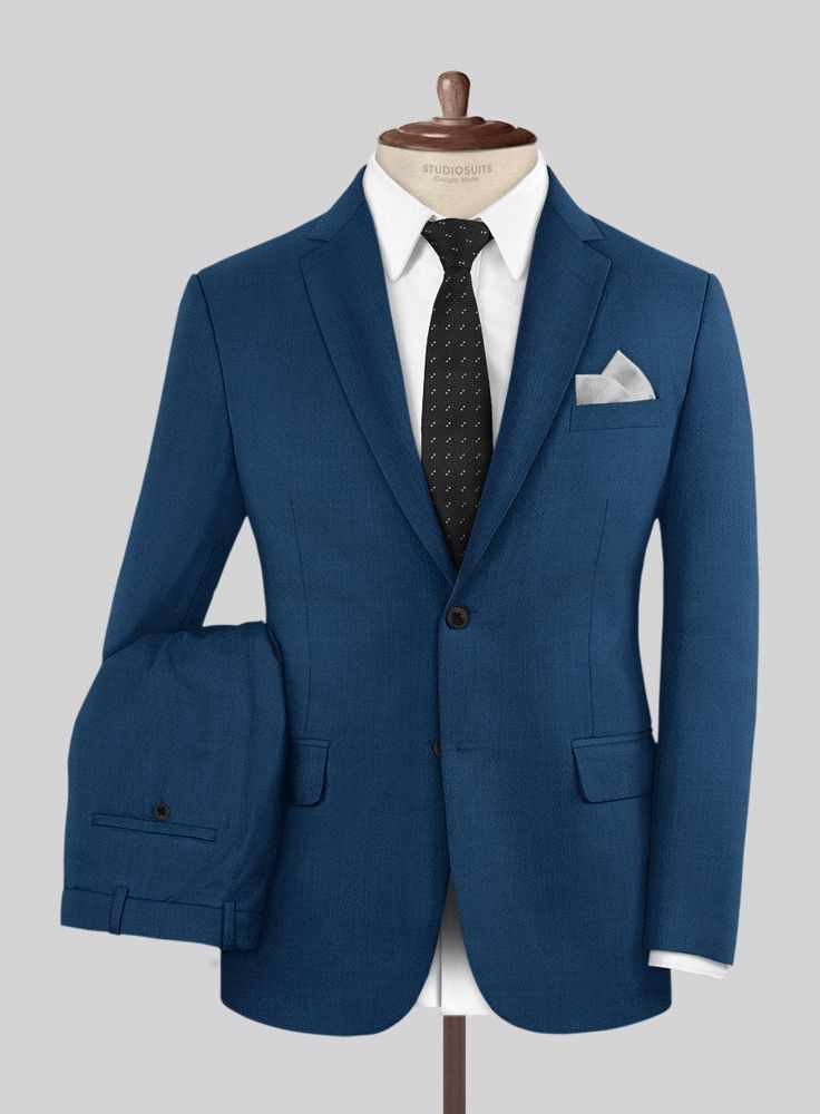 A suit is every gentleman's suit of armor and the machismo of a blue suit cannot be ignored. Crafted from pure wool, our Scabal Prussian Blue Wool Suit is a staple timeless piece every man needs in his wardrobe. Ideal for the boardroom, the altar, or any other nerve-jangling situation you might find yourself in. Achieve this professional look by teaming it up with a white formal shirt, tie and polished black shoes.  Look Includes  Scabal Prussian Blue Wool Fabric  Two Button Jacket Style  Notch Lapel  Horn Royal Black Buttons  Single Vent  Three Cuff Buttons  Two Welted Back Pockets on Trousers         Click 'Customize Now' to modify the look if needed.      Lining: 100% Viscose, Dry Clean. Classic Royal Blue Tuxedo With Notch Lapel, Classic Royal Blue Suit And Tie Accessories For Business, Classic Three-piece Suit With Notch Lapel In Royal Blue, Classic Royal Blue Tailored Tuxedo, Classic Three-piece Suit In Royal Blue With Notch Lapel, Tailored Blue Business Suits, Classic Royal Blue Three-piece Suit For Semi-formal Occasions, Classic Royal Blue Three-piece Suit For Semi-formal Events, Royal Blue Notch Lapel Tuxedo For Business