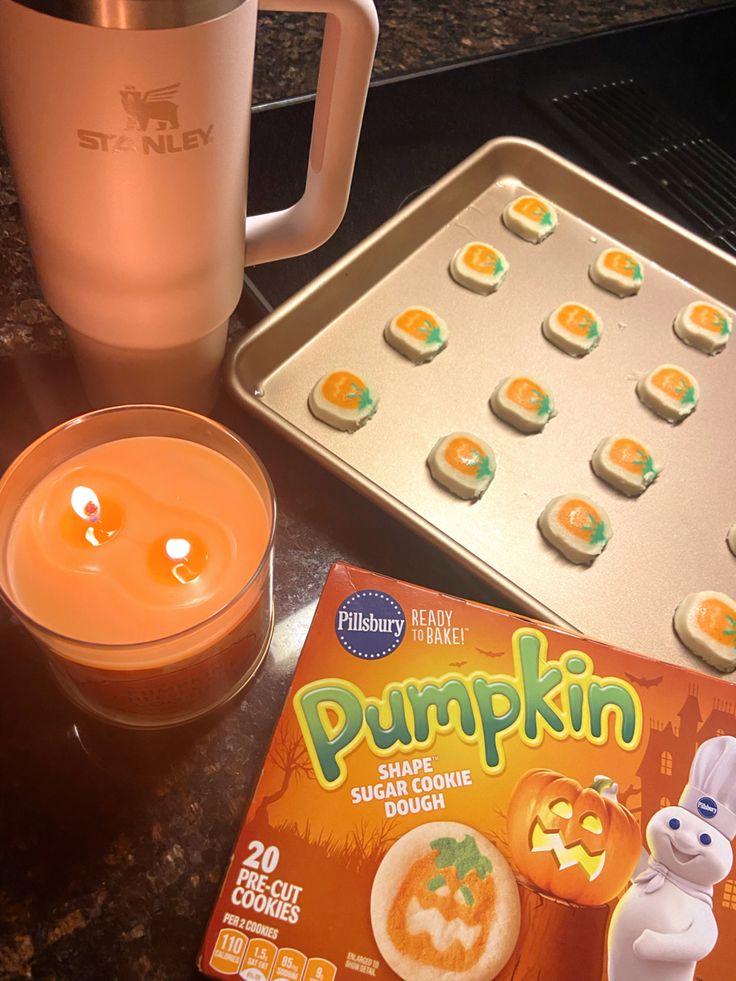 an orange drink and some cookies on a table