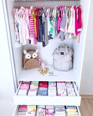 an organized closet with baby clothes and handbags