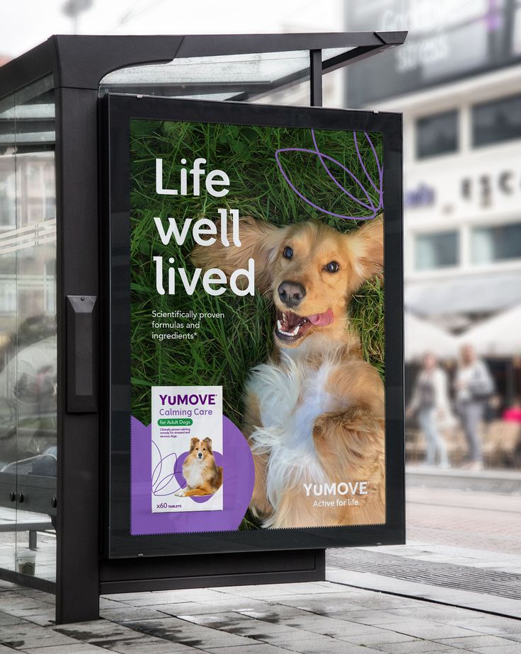 a billboard with a dog in the grass