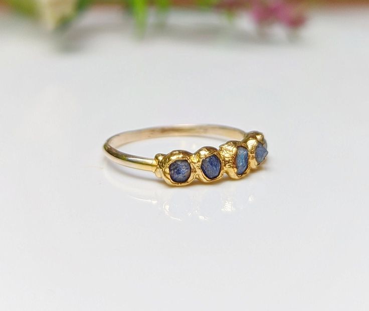 What's not to Love about this raw Sapphire Eternity ring ! Our September Birthstone ring features a row of 5-7 small raw blue Sapphires uniquely handcrafted on a Solid 14k Gold filled band. This lovely raw multi-stone ring will make a unique wedding band, but can also be offered as a gift on special occasions such as a birthday, anniversary, Mother's Day, Christmas, or Valentine's Day and would surely make a lovely alternative engagement ring! ❣T H E ∙ S M A L L ∙ D E T A I L S• 5-7 raw blue Sap Engagement Ring Blue Stone, Raw Sapphire, September Birthstone Ring, Birthstone Ring Mothers, Sapphire Eternity Ring, Unique Wedding Band, Raw Stone Jewelry, Blue Engagement Ring, September Birthstone Rings