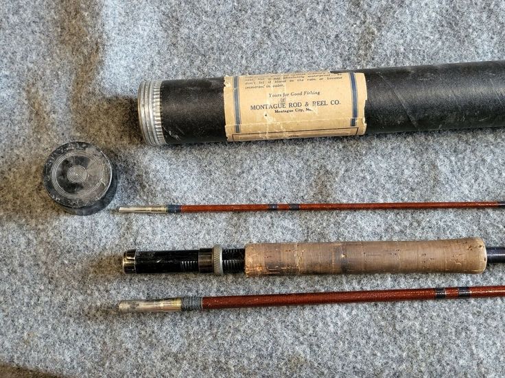 three different types of fishing rods laying on the ground next to an old canister