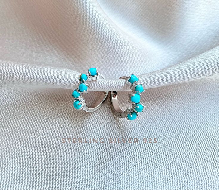 Genuine Turquoise Hoop Earrings made of Sterling Silver. High quality, and very precious. They are also available in Rose Gold over Sterling Silver and 18K Gold over Sterling Silver (925). Hoop thickness 1.5 mm, Outer Diameter: 1.4 cm. Inner Diameter 1 cm Stone: 5 small Genuine Turquoise , Size approximately 2 mm. **They come in pairs. We offer a free gift wrap option upon request. Just leave me a note at checkout saying that you would like your order gift wrapped. Our shop creates trendy design Elegant Turquoise Huggie Earrings Gift, Blue Hoop Earrings For Wedding, Elegant Turquoise Hypoallergenic Hoop Earrings, Turquoise Hoop Earrings As A Gift, Turquoise Hoop Earrings For Gift, Handmade Blue Huggie Hoop Earrings, Turquoise Hoop Huggie Earrings As Gift, Turquoise Round Huggie Earrings For Gift, Turquoise Huggie Earrings For Gift