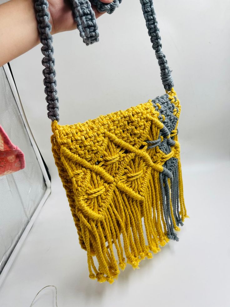 Add a different accessory to your wardrobe, make a statement with this eco-friendly Macrame Sling bag while feeling confident you are helping your earth.  Natural, simple and in Mustard & grey and creamy white this unlined bag is handcrafted by artisans in India from up-cycled cotton denim and recycled material in intricate knotted patterns in the macrame style. Tie the shoulder strap to your desired length. Customisable in any color. Size- Width- 9.5 Inches, Length- 9.5 Inches. Please let me know if you have any questions regarding any of my product.