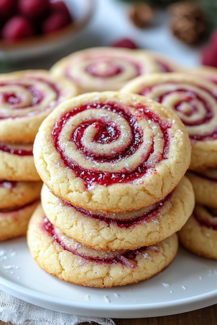 several cookies with raspberry filling on a white plate