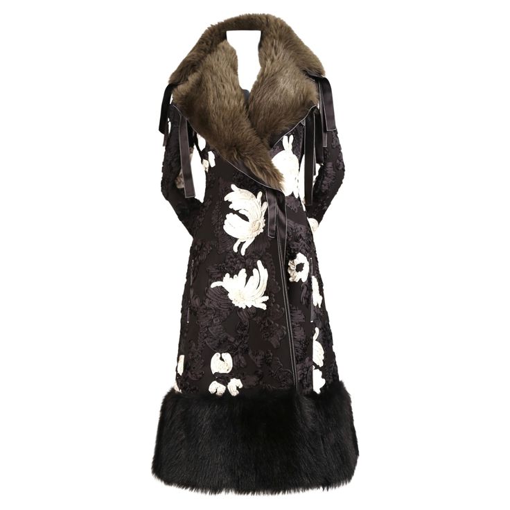 Cornely embroidered runway coat made of wool and silk with shearling collar and fox fur hem designed by Phoebe Philo exactly as seen on fall 2015 runway. This coat is the actual piece worn on the runway therefore it has no size tag however it fits a US 2. Approximate measurements: shoulders 15", bust 32-33", waist 26-27", arm length 27" and overall length 48". Unlined with French seams. Removable collar. Pockets at hips. Made in France. Excellent condition. Open closure. No belt is included. Ret Designer Silk Outerwear For Winter, Luxury Silk Winter Outerwear, Luxury Silk Long Coat Outerwear, Winter Silk Long Coat, Silk Long Coat For Winter, Black Shearling Coat, Celine Coat, Crombie Coat, Coat With Fur Trim