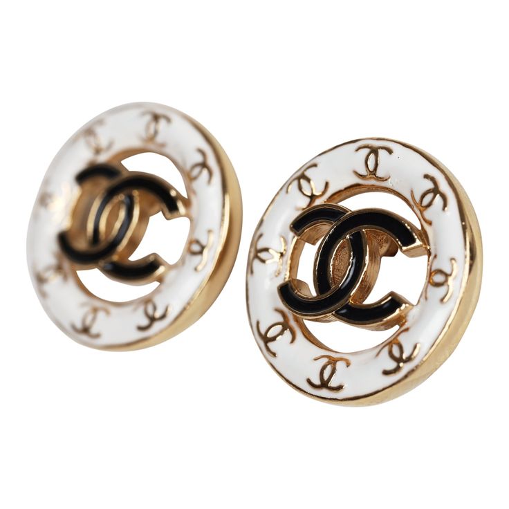 These Chanel CC round stud earrings feature a gold tone round cut-out detail stud earring with white enamel trim accented with mini gold tone CC's and one large black enamel CC logo in the center with post back closures.Origin: ItalyCondition: New and never wornAccompanied by: Chanel box, jewelry box, carebook, retail UPCMeasurements: 0.6" x 0.6" Luxury White Enamel Earrings, Luxury White Pierced Earrings, Designer White Earrings For Formal Occasions, Elegant White Enamel Earrings, Luxury Yellow Gold Enamel Earrings, Classic Enamel Earrings For Formal Occasions, Classic Formal Enamel Earrings, Designer Round Pierced Jewelry, Formal White Jewelry With Black Enamel