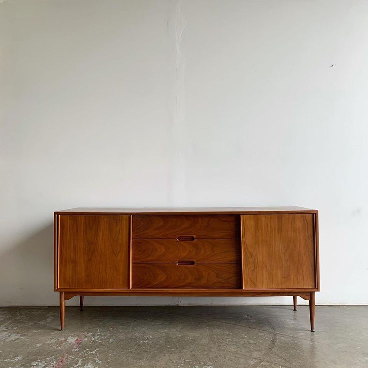 the sideboard has two drawers and is made out of wood