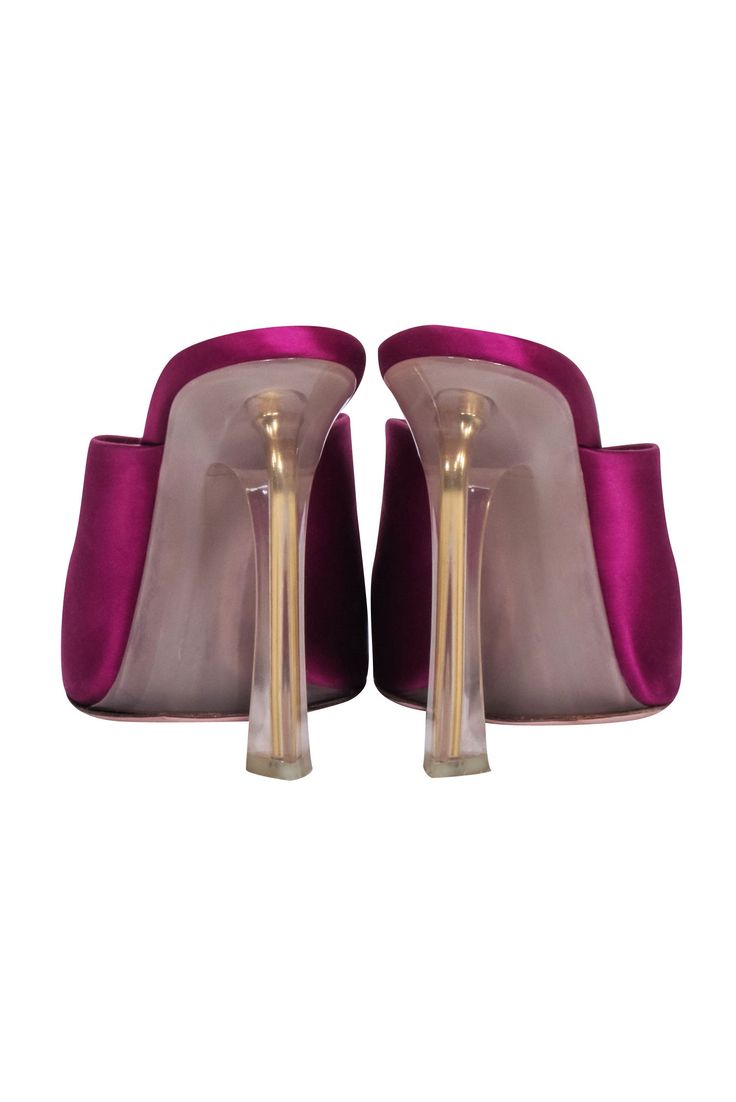 Step out in head-turning style with these Nina Ricci magenta pink satin mule pumps. The open toe heel showcases a clear heel design for a light and airy look, perfect for any date night. Make a statement and show off your fashion-savvy with these eye-catching and chic mules! Size 7.5 Satin fabric upper Clear acrylic heel Pointed toe Heel height 4" Pink Open Toe Mules For Formal Occasions, Party Sandals With Sculpted Heel And Slip-on Design, Party Sandals With Sculpted Heel And Slip-on Style, Pink Sandals With Deep Heel Cup For Party, Pink Closed Toe Mules For Evening, Pink Evening Mules With Padded Heel, Pink High Heel Mules For Formal Occasions, Pink Open Toe Mules For Party, Party Slip-on Heels With Padded Heel