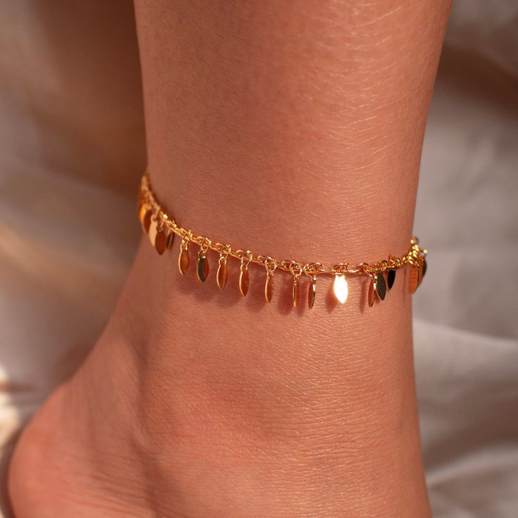 Step into the party with glamour and grace wearing our Gold Chacha Anklet - adorned with delicate leaves for a touch of natural elegance. This ankle bracelet isn't just a gift; it's a dazzling expression of style and sophistication, making it the perfect accessory to elevate her look with a gorgeous sparkle! #YOU MAY LIKE THIS Birthstone anklet https://www.etsy.com/listing/1545880373/birthstone-anklet-shiny-layered-chain dainty gold anklet https://www.etsy.com/listing/1699658668/dainty-gold-ankl Dangle Anklets For Parties, Rose Gold Anklets For Party, Gold Metal Wedding Anklet, Bohemian Gold Anklets For Party, Elegant Gold Chain Anklet, Elegant Gold Crystal Anklets, Gold Metal Chain Anklets, Ankle Bracelets Gold, Wedding Anklets