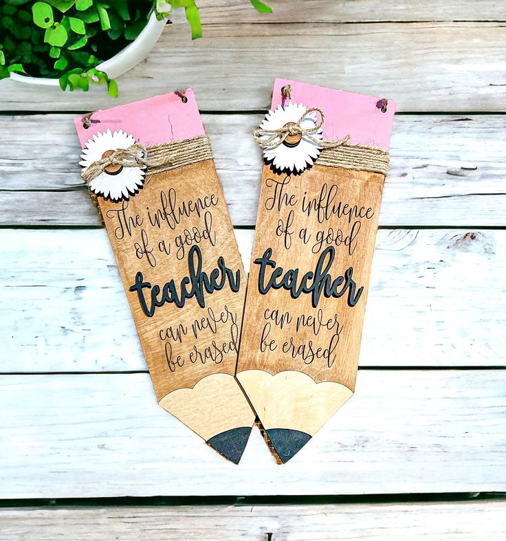 two wooden teachers bookmarks with flowers on them