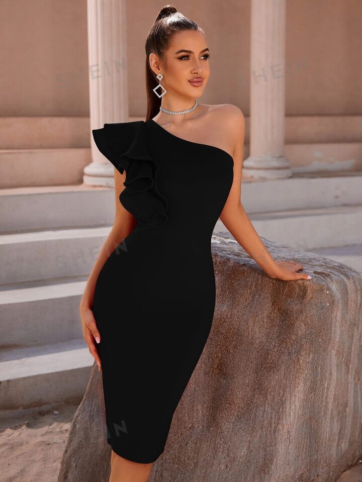 a woman in a black dress posing for the camera