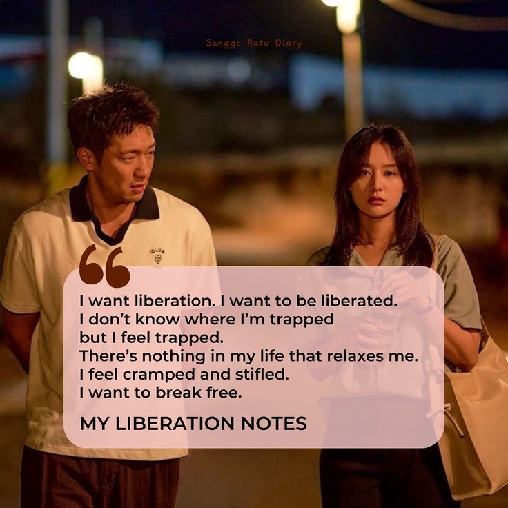 a man and woman standing next to each other with a note in front of them