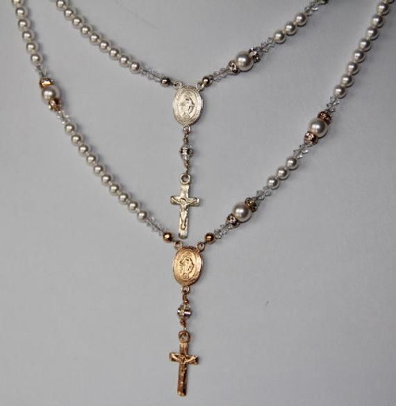 "This Catholic Rosary Necklace is stunning...and it is complete with all five decades of the Holy Rosary. This necklace can be blessed as a sacramental. A beautiful gift for Birthday, Wedding, Communion or Confirmation, Mother's Day, Sympathy/Courage...or any special expression of love. I created this Rosary necklace using 4mm Swarovski crystal white pearls for the Ave's, and 6mm white pearls for the Pater's. Surrounding the Pater's are gold 4mm crystal or AB crystal rondelles and 3mm crystal bi Spiritual Crucifix Jewelry For Wedding, Elegant Gold Rosary As Gift, Elegant Gold Rosary For Gift, Elegant Crucifix Necklace For First Communion, Elegant Gold Rosary For Anniversary, Engraved Crucifix Jewelry For Wedding, White Miraculous Medal Necklace For Wedding, Wedding Crucifix Jewelry Engraved, Elegant Gold Anniversary Rosary