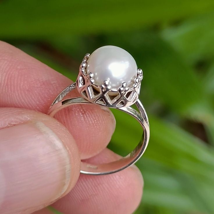 Freshwater White Pearl 925 Sterling Solid Silver Handmade Ring for Girls / Women. This charming handmade ring captures the essence of timeless elegance with a touch of playful sparkle. A luminous freshwater pearl, its surface kissed by moonlight, takes centre stage, nestled in a delicate polished 925 sterling silver setting. Crafted with Care: Each ring is lovingly crafted by hand, ensuring no two are exactly alike. Skilled artisans pour their passion into creating a piece that whispers with quality and attention to detail. The gentle shimmer of the pearl and the soft lustre of the silver combine to create a ring that's both classic and captivating. A Touch of Charm for Every Girl: From princess parties to everyday adventures, this pearl ring adds a touch of magic to any girl's outfit. Its Elegant Birthstone Rings As Gift, Classic Pearl Promise Ring, Elegant Gemstone Rings As Gift, Sterling Silver Pearl Ring Fine Jewelry, Fine Jewelry Sterling Silver Pearl Ring With Oval Shape, Elegant Pearl Ring With Prong Setting, Fine Jewelry Oval Pearl Ring In Sterling Silver, Oval Sterling Silver Pearl Ring, Exquisite Pearl Ring For Anniversary