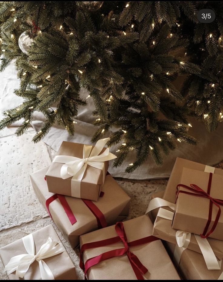 several wrapped presents under a christmas tree