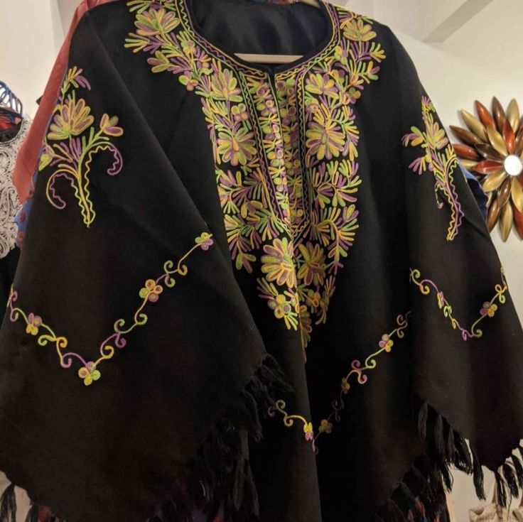 Beautiful Kashmiri Embroidered Woolen Cape Free Size Festival Black Embroidered Poncho, Winter Festival Embroidered Poncho, Winter Embroidered Long Sleeve Poncho, Traditional Embroidered Poncho For Winter, Traditional Embroidered Winter Poncho, Traditional Long Sleeve Embroidered Poncho, Embroidered Long Sleeve Poncho For Festival, Festival Poncho With Multicolor Floral Embroidery, Spring Festival Embroidered Poncho