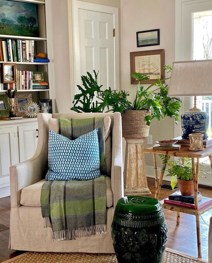 a living room filled with furniture and lots of plants