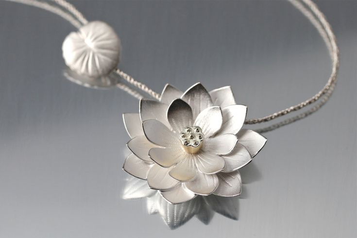 Lotus pendant necklace in stunning detail and exaggerated scale, even the clasp is a handmade lily-pad. Handmade in the USA Bright white, matte pickled finish 925 Sterling silver Flower measures approximately 1" across 18" matching silver chain included Goldmakers Jewelry Mission Statement Goldmakers Jewelry creates and curates a comprehensive selection of artfully designed hand-crafted jewelry. We aspire to offer the jewelry enthusiast access to affordable classics as well as fresh innovative d Brass Cookware, Diamond Earrings Indian, Silver And Gold Jewelry, Lotus Jewelry, Lotus Necklace, Lotus Pendant, Accesories Jewelry, School Jewelry, Silver Jewelry Design