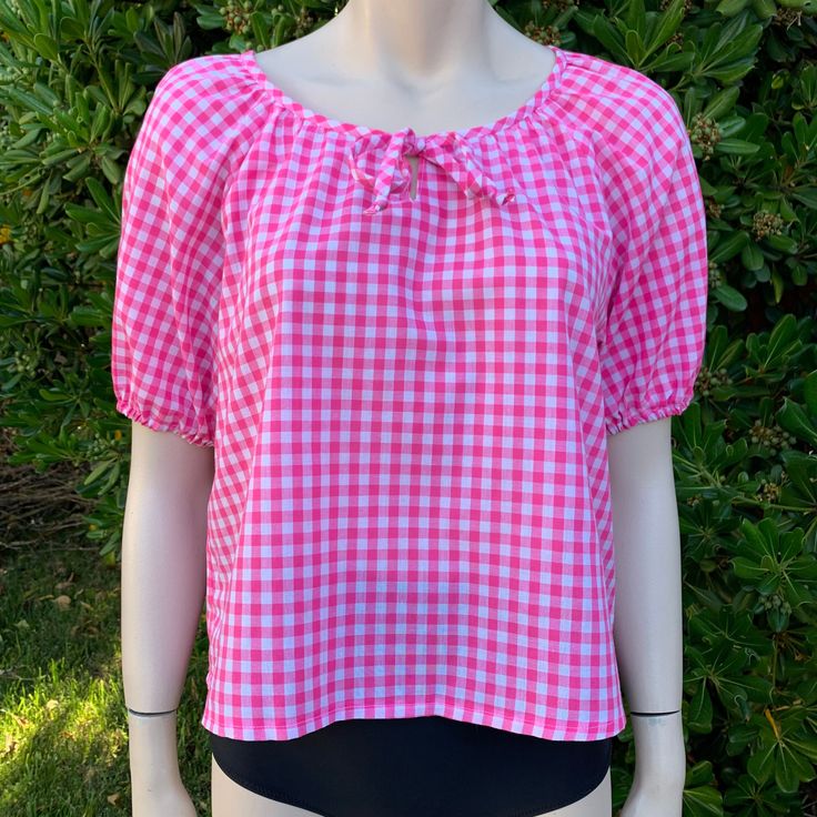 This is a super cute pink gingham blouse I love the little tie on the chest and the poof sleeves! It's also sort of cropped so that just makes it extra cute! It's very lightweight and perfect for summer My guess would be best fits up to a medium but pls see measurements as there is no tag on this! Measurements as follows: Pit to pit is 19" inches  Length is 22" inches I ship priority mail with tracking! Thanks for looking :) Summer Gingham Blouse For Picnic, Summer Plaid Blouse For Picnic, Summer Plaid Blouse For Day Out, Gingham Tops For Beach In Spring, Short Sleeve Gingham Blouse For Day Out, Summer Picnic Fitted Blouse, Fitted Summer Blouse For Picnic, Spring Gingham Blouse For Picnic, Spring Gingham Blouse For Picnics