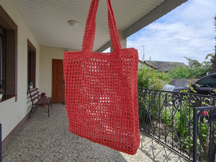 a red bag hanging from the side of a building