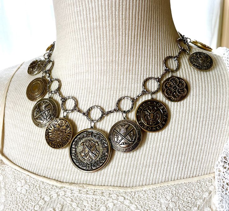 "Here is a great collection of mid-1900's gold and silver tone buttons, on a classic antiqued loop and connector chain necklace. These are lightweight, largely hollow buttons. The chain length is adjustable from 18\" to 20\" long. The pictures show the longest and shortest lengths possible. I work with antique and vintage parts. Some may show signs of wear or age. Please look at each picture closely. I have tried to show all aspects of my work. Please contact me before purchasing if you have any Antique Button Jewelry, Vintage Jewelry Diy, Statement Necklace Gold, Vintage Rhinestone Earrings, Assemblage Necklace, Assemblage Jewelry, Gold Statement Necklace, Falmouth, Antique Buttons