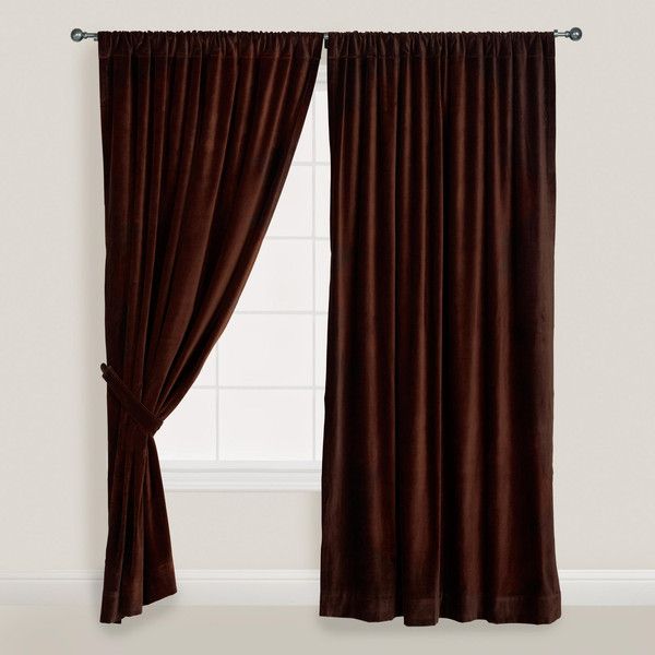 the curtain is open and ready to be hung in front of a window with dark brown curtains