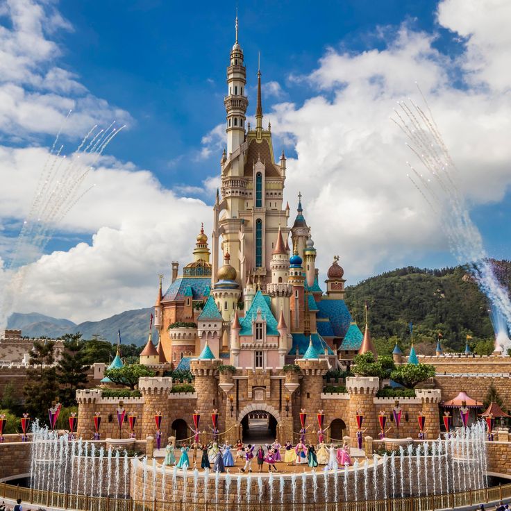 the castle is surrounded by fountains and people