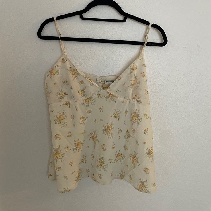 Vintage Polo - Floral Camisole Tank In Cream Next Day Shipping // Never Worn Super Cute Silk Tank/Camisole Available Only At Polo / Polo Jeans. Cut In A Boxy Fit With A Cute V-Neck And Adjustable Straps With A Light Material Finish. Complete With Retro Floral Design And Cream Colorway. Nwot! Discontinued Piece! Retails $75 Size: Xl, Could Fit A Medium Or Large. Message Me With Questions! Tagged For Exposure! #Polo #Summer #Camisole #Floral #Europe Towel Cami Beach Vacation Loungewear Cream Boho White V-neck Tank Top With Floral Print, Spring V-neck Camisole For Daywear, Feminine Floral Print Tank Top For Day Out, Feminine Cami Tank Top For Vacation, Fitted V-neck Tank Top With Floral Print, Fitted Sleeveless Blouse Camisole For Vacation, Fitted Floral Print V-neck Tank Top, White Floral Print V-neck Tank Top, Fitted Cami Blouse For Daywear