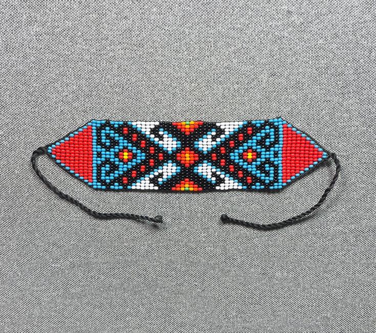 a beaded headband with an orange, blue and red design on the side