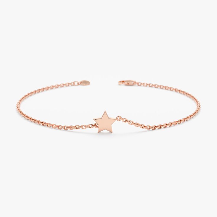 Capella This celestial spark of a bracelet captures the magic of the night sky in a dainty and sophisticated design. The bracelet features a tiny, hand-crafted solid gold star charm that dangles from a shimmering gold chain. Available in 14k yellow, rose, or white gold, this bracelet is perfect for everyday wear or adding a touch of starlight to a special occasion. - Handmade- Solid Gold- The Dimension of Star: 5.5 mm All pieces come beautifully boxed in suede pouches you can always use when tra 14k Gold Dainty Bracelet With Star Charm, Dainty 14k Gold Bracelet With Star Charm, Yellow Gold Star Charm Bracelet, Dainty Yellow Gold Star Bracelet, Elegant Yellow Gold Star Bracelet, Adjustable Yellow Gold Star Bracelet, Elegant Adjustable Star-shaped Chain Bracelet, 14k Yellow Gold Bracelet With Star Charm, Adjustable Star-shaped Celestial Bracelets